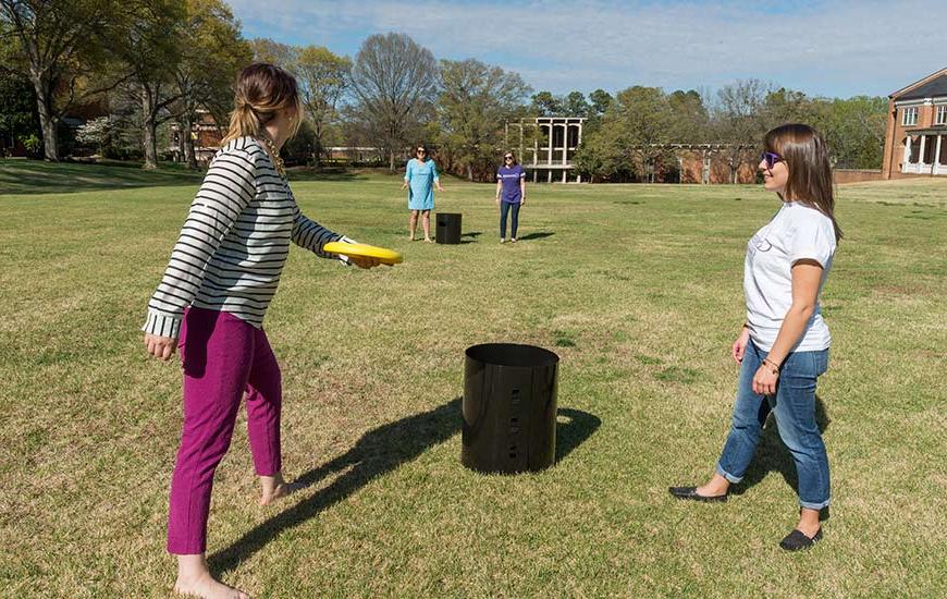 Students playing with frisbees